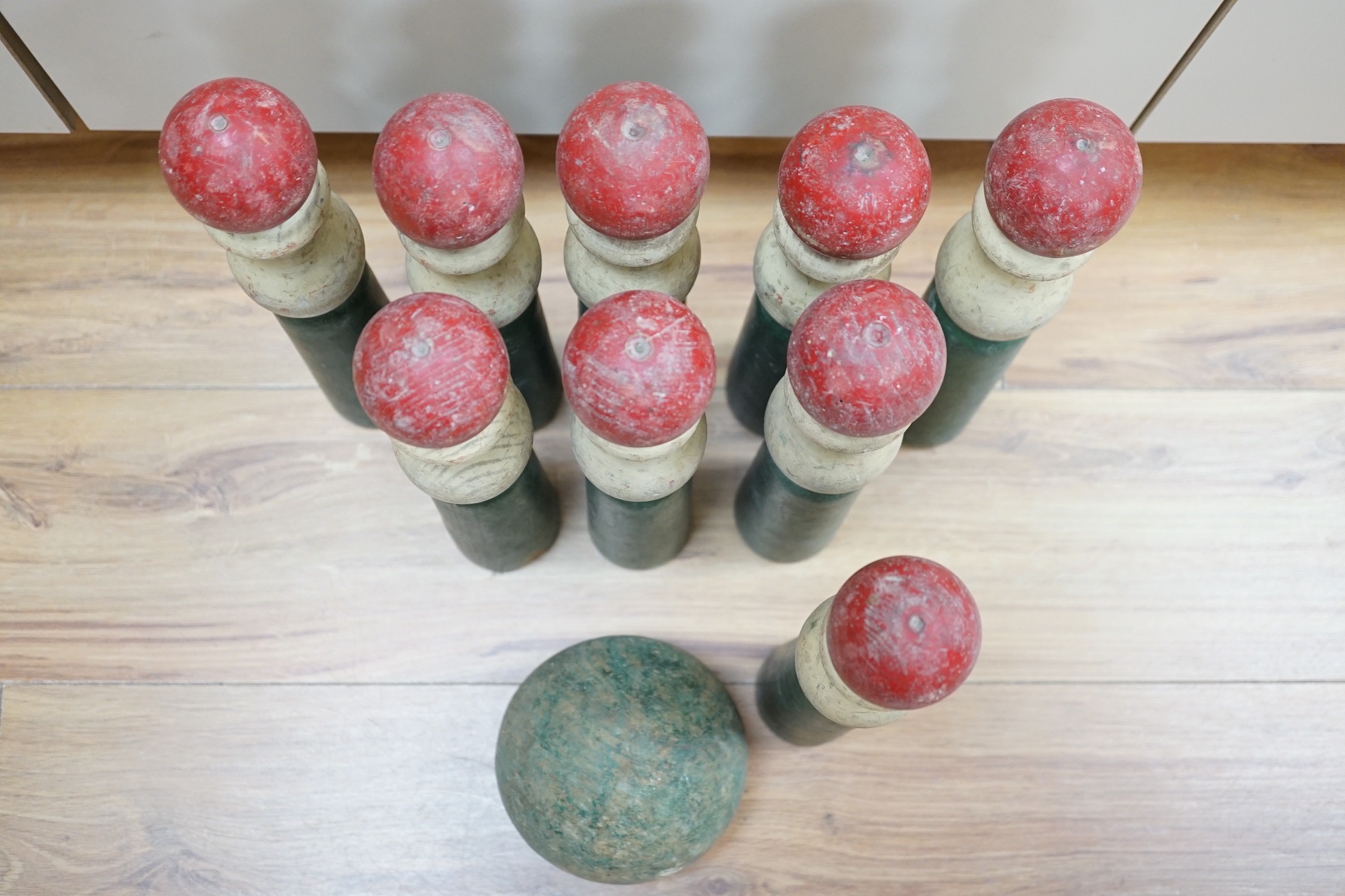 A set of turned wooden skittles and ball